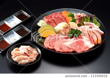 Meat and vegetables served on a black plate - Assortment of premium grilled meat ingredients - Assortment of wagyu beef, chicken, pork and vegetables 113500816