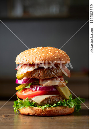 Fresh burger on an old kitchen table. 113502889