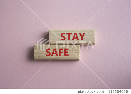 Stay Safe symbol. Concept word Stay Safe on wooden blocks. Beautiful pink background. Business and Stay Safe concept. Copy space 113504036