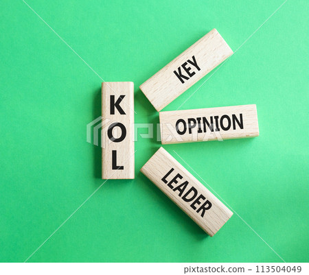KOL - Key Opinion Leader symbol. Concept word KOL on wooden blocks. Beautiful green background. Business and KOL concept. Copy space. 113504049