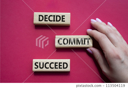 Decide Commit Succeed symbol. Concept words Decide Commit Succeed on wooden blocks. Businessman hand. Beautiful red background. Business concept. Copy space. Decide Commit Succeed symbol. Concept words Decide Commit Succeed on wooden blocks. Businessman hand. Beautiful red background. Business concept. Copy space. 113504119