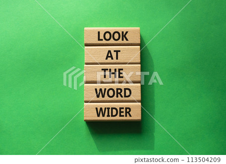 Look at the world wider symbol. Wooden blocks with words Look at the world wider. Beautiful green background. Business and Look at the world wider concept. Copy space. 113504209