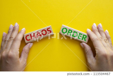 Chaos or Order symbol. Concept word Chaos or Order on wooden blocks. Businessman hand. Beautiful white background. Business and Chaos or Order concept. Copy space Chaos or Order symbol. Concept word Chaos or Order on wooden blocks. Businessman hand. Beautiful white background. Business and Chaos or Order concept. Copy space 113504467