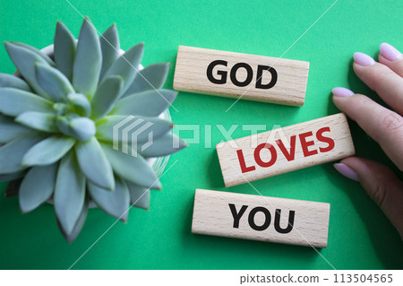 God loves you symbol. Wooden blocks with words God loves you. Beautiful green background with succulent plant. Prayer hand. Religion and God loves you concept. Copy space. God loves you symbol. Wooden blocks with words God loves you. Beautiful green background with succulent plant. Prayer hand. Religion and God loves you concept. Copy space. 113504565