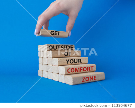 Get outside of your comfort zone symbol. Concept words Get outside of your comfort zone on wooden blocks. Businessman hand. Beautiful blue background. Business concept. Copy space. 113504677