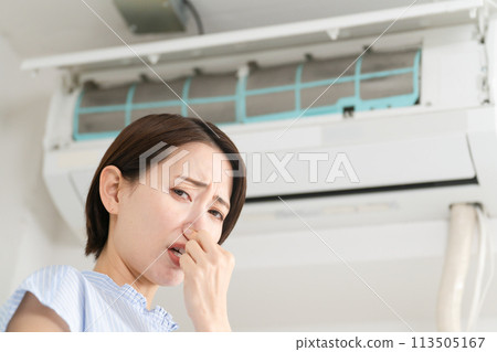 Young woman who is concerned about the smell of the air conditioner Lifestyle image 113505167