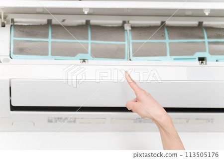Young woman cleaning air conditioner filters Lifestyle image 113505176