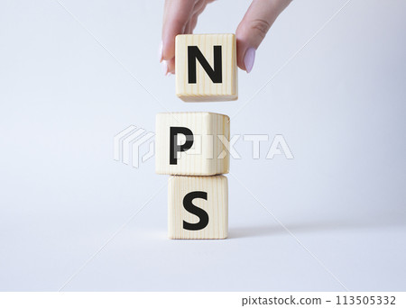 NPS - Net Promoter Score symbol. Wooden cubes with words NPS. Businessman hand. Beautiful white background. Business and NPS concept. Copy space. NPS - Net Promoter Score symbol. Wooden cubes with words NPS. Businessman hand. Beautiful white background. Business and NPS concept. Copy space. 113505332
