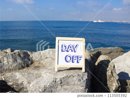 Day off symbol. Day off white chalk blackboard. Beautiful sea background. Business and Day off concept. Copy space. 113505392