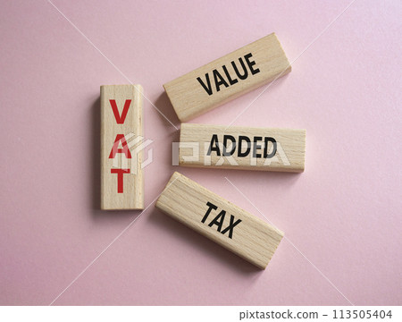 VAT - Value Added Tax symbol. Wooden cubes with word VAT. Beautiful pink background. Business and Value Added Tax concept. Copy space. 113505404