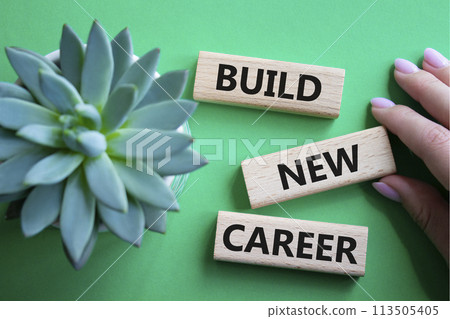 Build new career symbol. Concept word Build new career on wooden blocks. Businessman hand. Beautiful green background. Business and Build new career concept. Copy space Build new career symbol. Concept word Build new career on wooden blocks. Businessman hand. Beautiful green background. Business and Build new career concept. Copy space 113505405