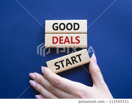 Good Deals Start symbol. Concept words Good Deals Start on wooden blocks. Businessman hand. Beautiful deep blue background. Business concept. Copy space. 113505411