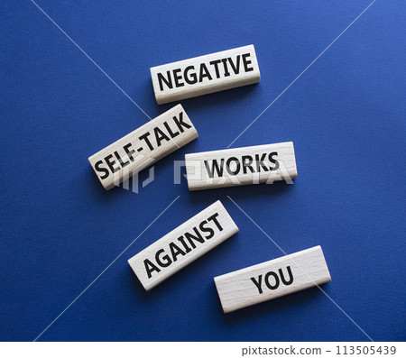 Negative self-talk works against you symbol. Concept words Negative self-talk works against you on wooden blocks. Beautiful deep blue background. Psychological concept. Copy space Negative self-talk works against you symbol. Concept words Negative self-talk works against you on wooden blocks. Beautiful deep blue background. Psychological concept. Copy space 113505439
