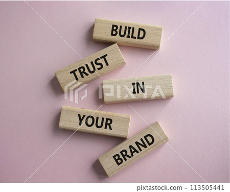Build trust in your brand symbol. Wooden blocks with words Build trust in your brand. Beautiful pink background. Business and Build trust in your brand concept. Copy space. 113505441
