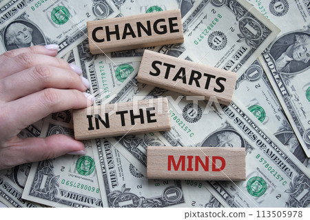 Change starts in the mind symbol. Concept words Change starts in the mind on wooden blocks. Beautiful dollar background. Businessman hand. Business and Change starts in the mind concept. Copy space Change starts in the mind symbol. Concept words Change starts in the mind on wooden blocks. Beautiful dollar background. Businessman hand. Business and Change starts in the mind concept. Copy space 113505978