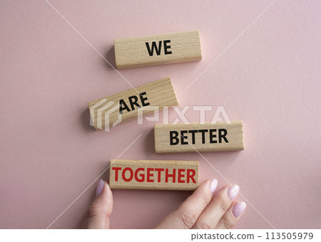 We are better together symbol. Wooden blocks with words We are better together. Beautiful pink background. Businessman hand. We are better together concept. Copy space. We are better together symbol. Wooden blocks with words We are better together. Beautiful pink background. Businessman hand. We are better together concept. Copy space. 113505979