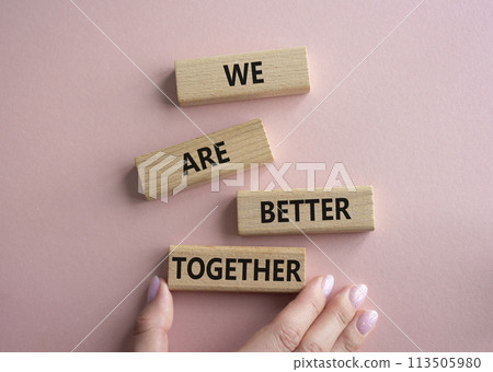 We are better together symbol. Wooden blocks with words We are better together. Beautiful pink background. Businessman hand. We are better together concept. Copy space. We are better together symbol. Wooden blocks with words We are better together. Beautiful pink background. Businessman hand. We are better together concept. Copy space. 113505980