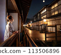 Night view of the inn district. A woman is looking at the moon. 113506896