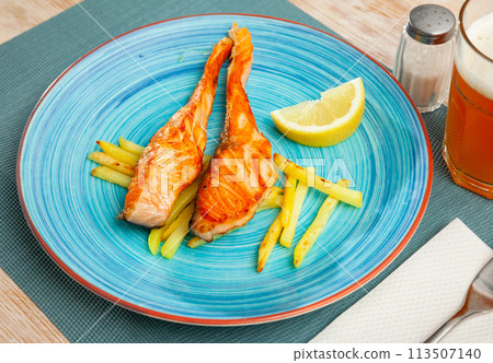 Tasty grilled salmon served with french fries 113507140