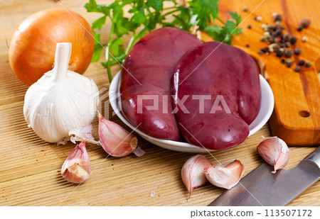 Raw pork kidneys with seasonings 113507172