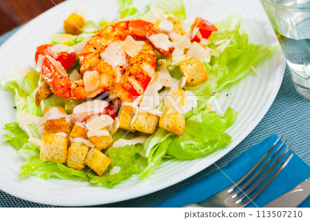 Caesar salad with prawns, lettuce, sauce and cheese 113507210