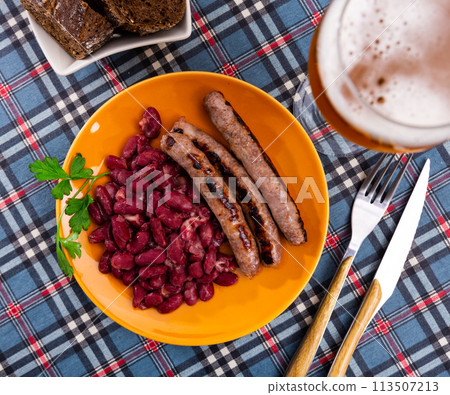 Fried pork sausage botifarra with stewed red beans Fried pork sausage botifarra with stewed red beans 113507213