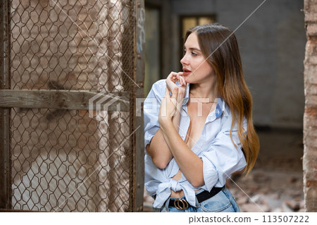 Desirable young woman posing in deserted building Desirable young woman posing in deserted building 113507222