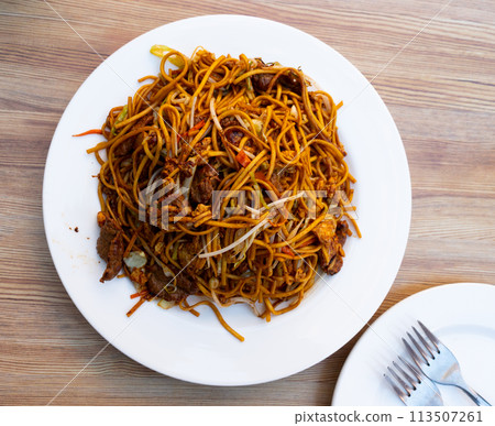 Fried wheat noodles with veal fillet and vegetables Fried wheat noodles with veal fillet and vegetables 113507261