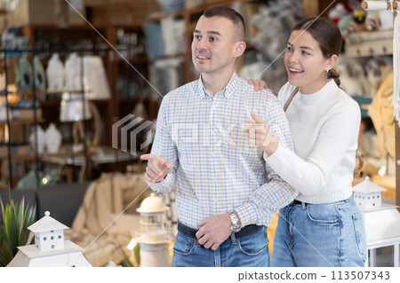 Couple inspect furniture store, searching for perfect item to buying. 113507343
