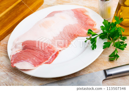 Raw meat, pork steaks with spices on white plate 113507346