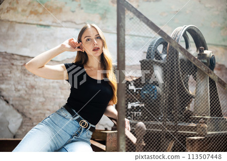 Attractive woman posing in deserted industrial building Attractive woman posing in deserted industrial building 113507448