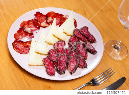 Appetizing cold cuts from sausage, cheese and ham on serving plate closeup 113507451