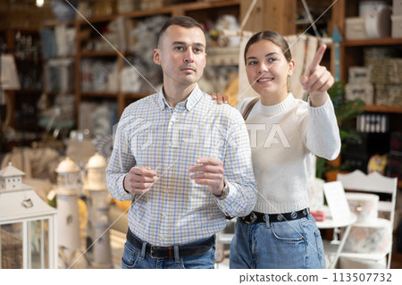 Couple man and woman choose furniture in store 113507732