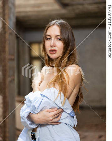 Sensual woman undressing in deserted building 113507741