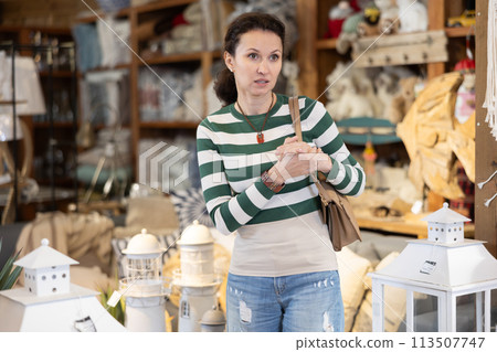 Woman inspect furniture store, searching for perfect item to buying. Woman inspect furniture store, searching for perfect item to buying. 113507747