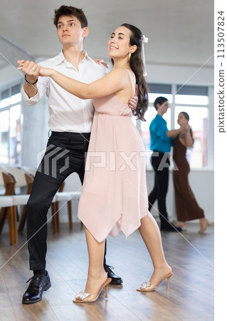 Couple young woman and man dancing latin dances 113507824