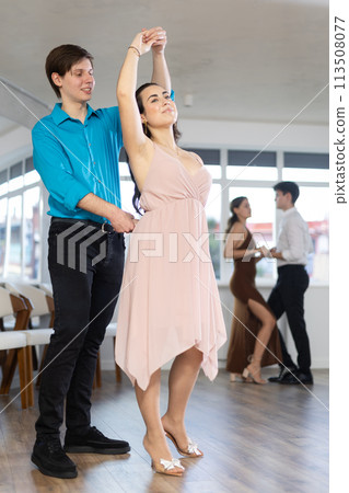 Young couple sensual performing kizomba in dance studio Young couple sensual performing kizomba in dance studio 113508077