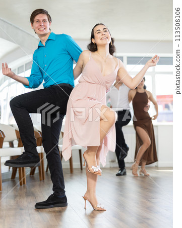Several couples of happy young people in festive clothes dance foxtrot 113508106