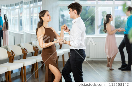 Latin American guy and girl performing kizomba in dance studio 113508142