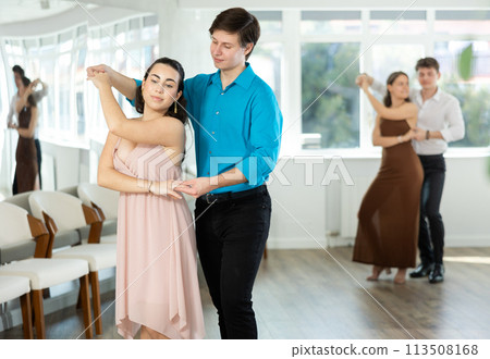 During rehearsal, guy and girl participants of dance workshop perform social pair dance 113508168