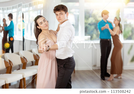 Stylish young couple rehearsing elegant waltz in choreographic studio 113508242