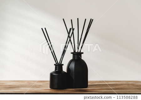 Minimalist Aromatic Reed Diffusers on a Wooden Surface Against a Soft Background 113508288