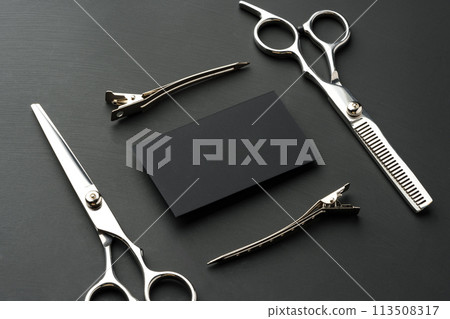 Hairdressing scissors and businesscard mock up on black background Hairdressing scissors and businesscard mock up on black background 113508317