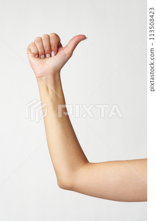 Female hand showing thumbs up sign against white background Female hand showing thumbs up sign against white background 113508423