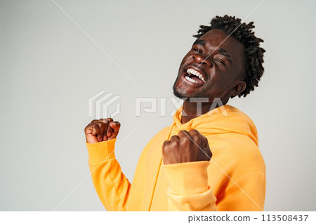 Happy Young African Man Gesturung Joy and Success Happy Young African Man Gesturung Joy and Success 113508437