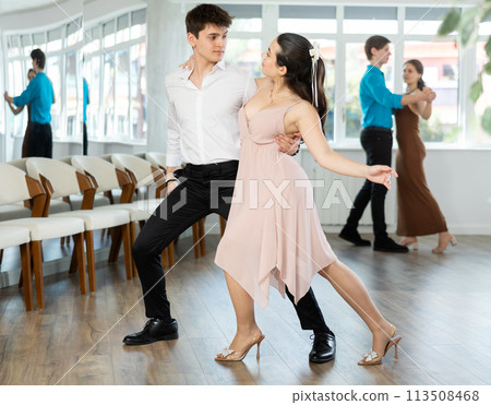 Couple young woman and man dancing latin dances Couple young woman and man dancing latin dances 113508468