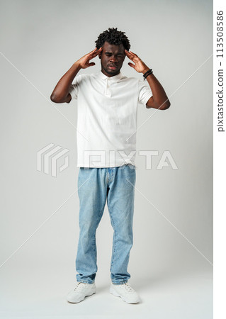 African man with his hands on his head, expressing frustration and stress African man with his hands on his head, expressing frustration and stress 113508586