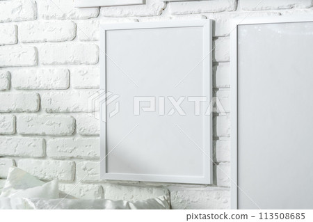 Varied Sized Photo Frames Displayed on a White Brick Wall Varied Sized Photo Frames Displayed on a White Brick Wall 113508685