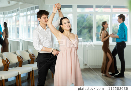 During rehearsal, guy and girl participants of dance workshop perform social pair dance During rehearsal, guy and girl participants of dance workshop perform social pair dance 113508686