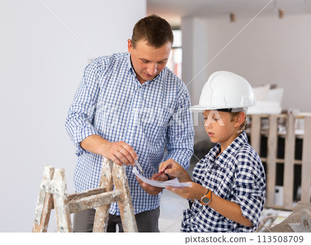 Father with little son talking about repair work in the apartment Father with little son talking about repair work in the apartment 113508709
